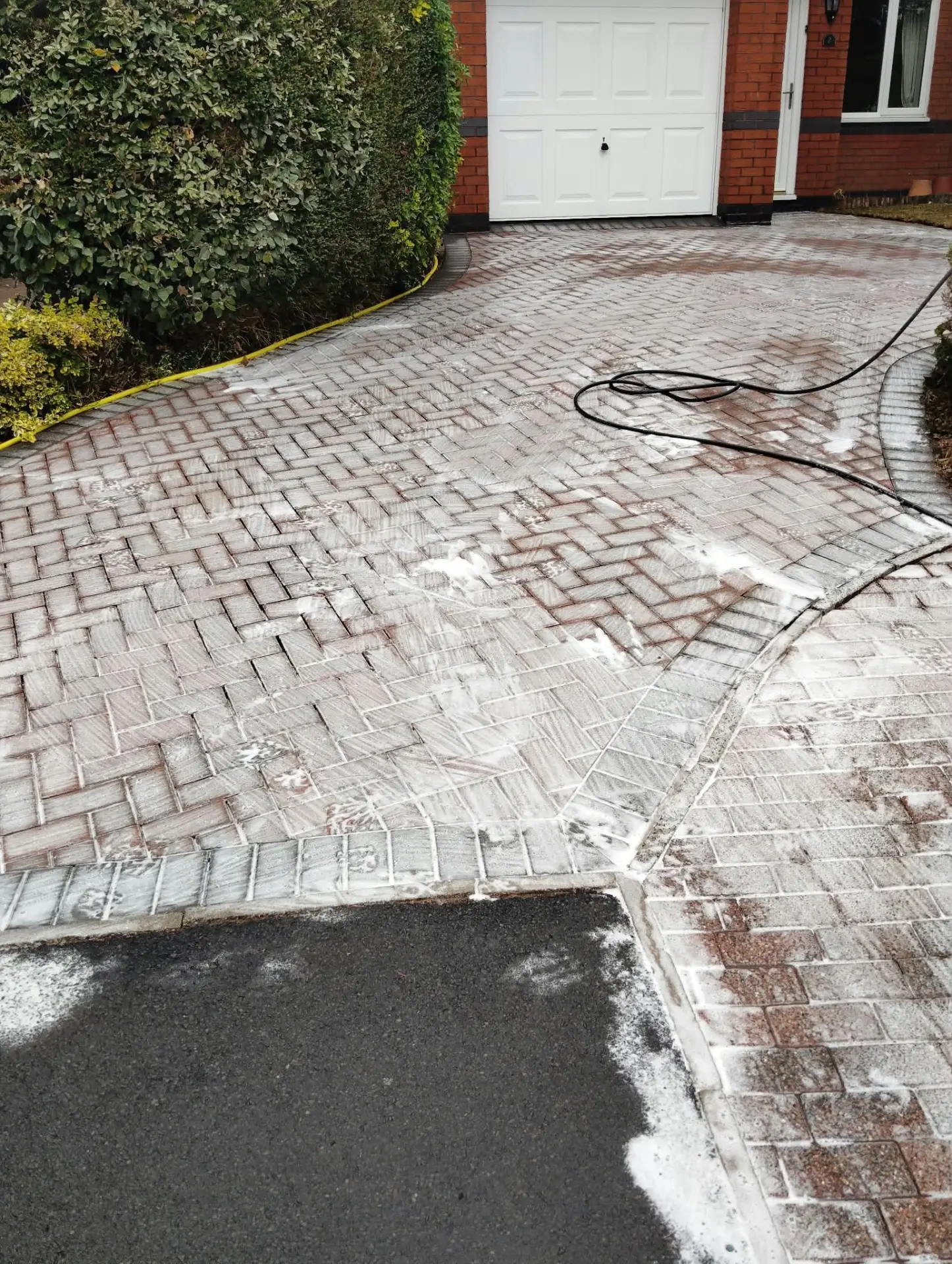 Block paving treated with cleaning detergent during a deep pressure wash