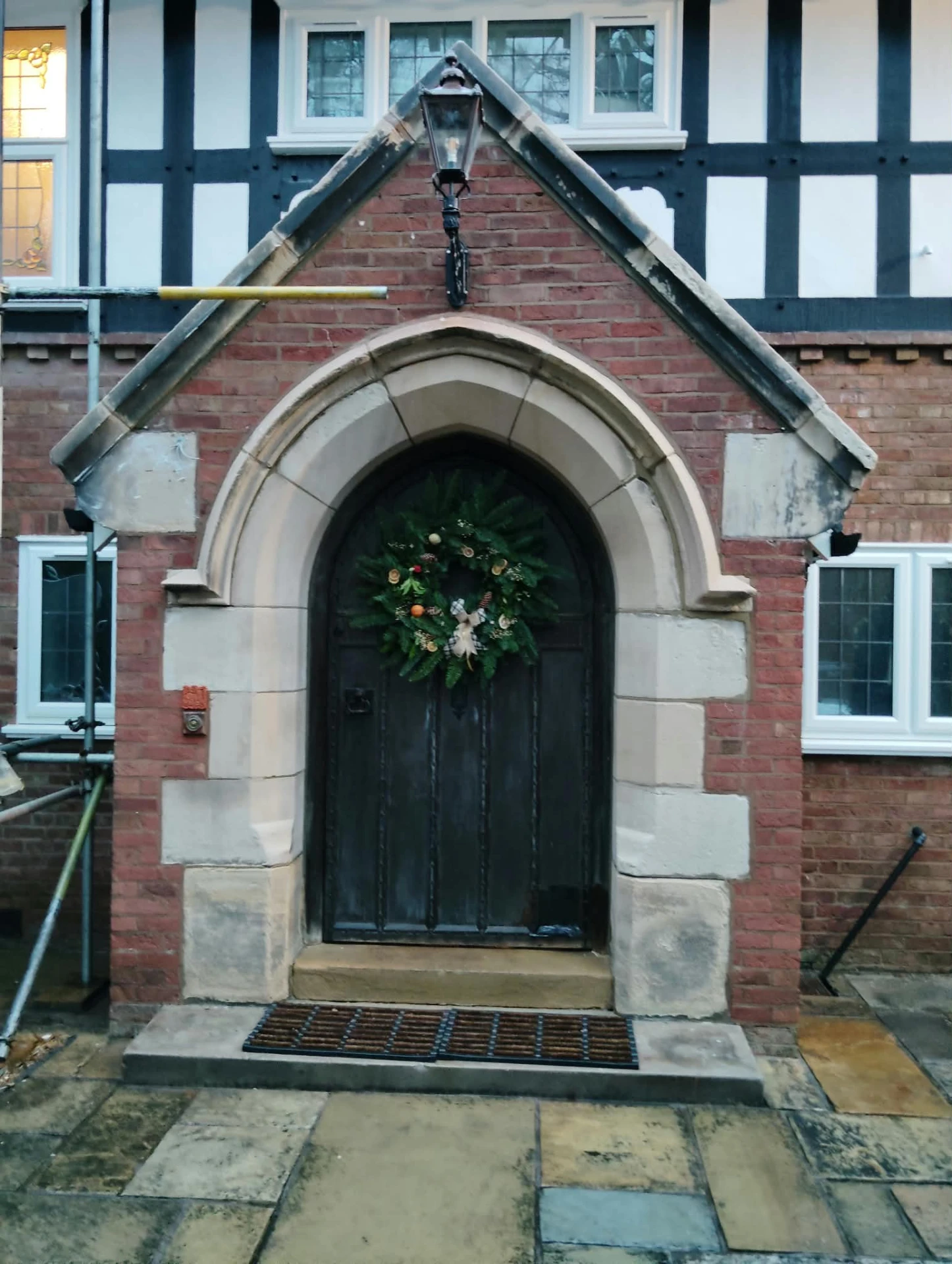 Arched oak door and sandstone porch surround cleaned back to original tone