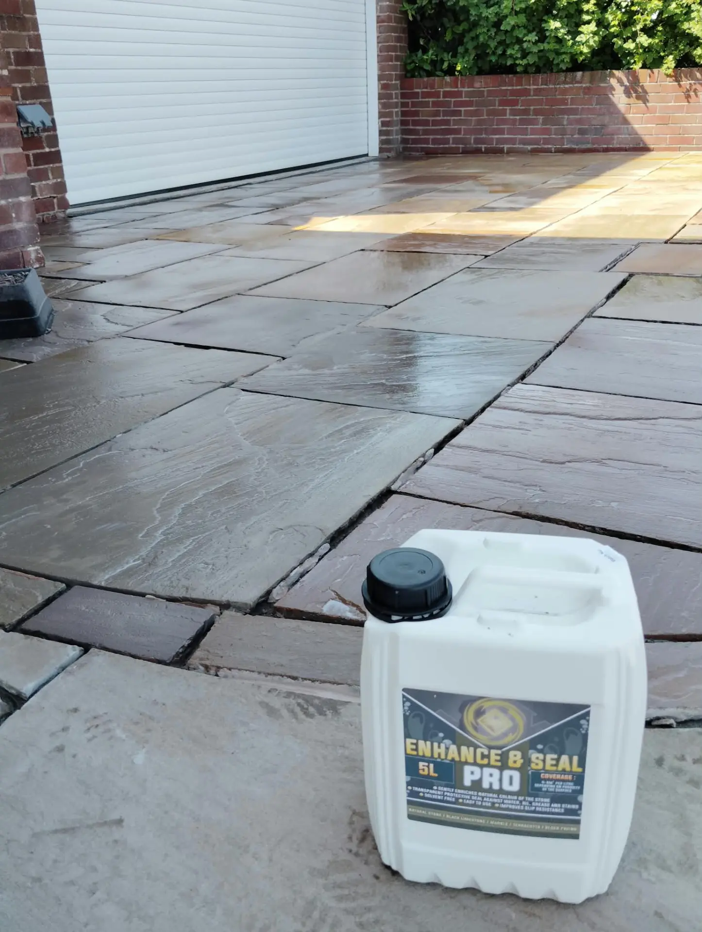 Sandstone driveway freshly sealed with Enhance and Seal Pro, showing a rich wet-look finish