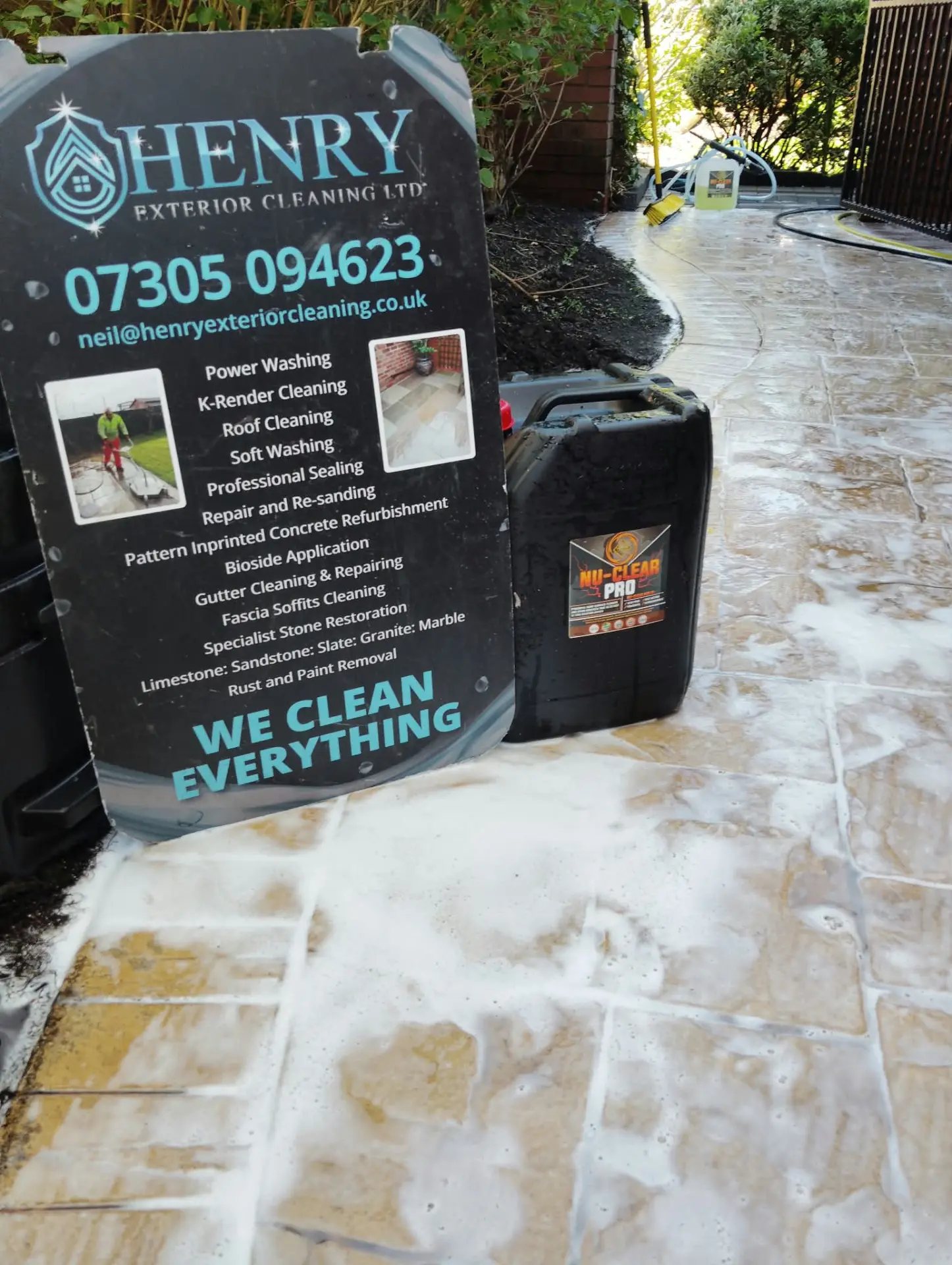 Pattern imprinted concrete patio being deep cleaned with professional detergent