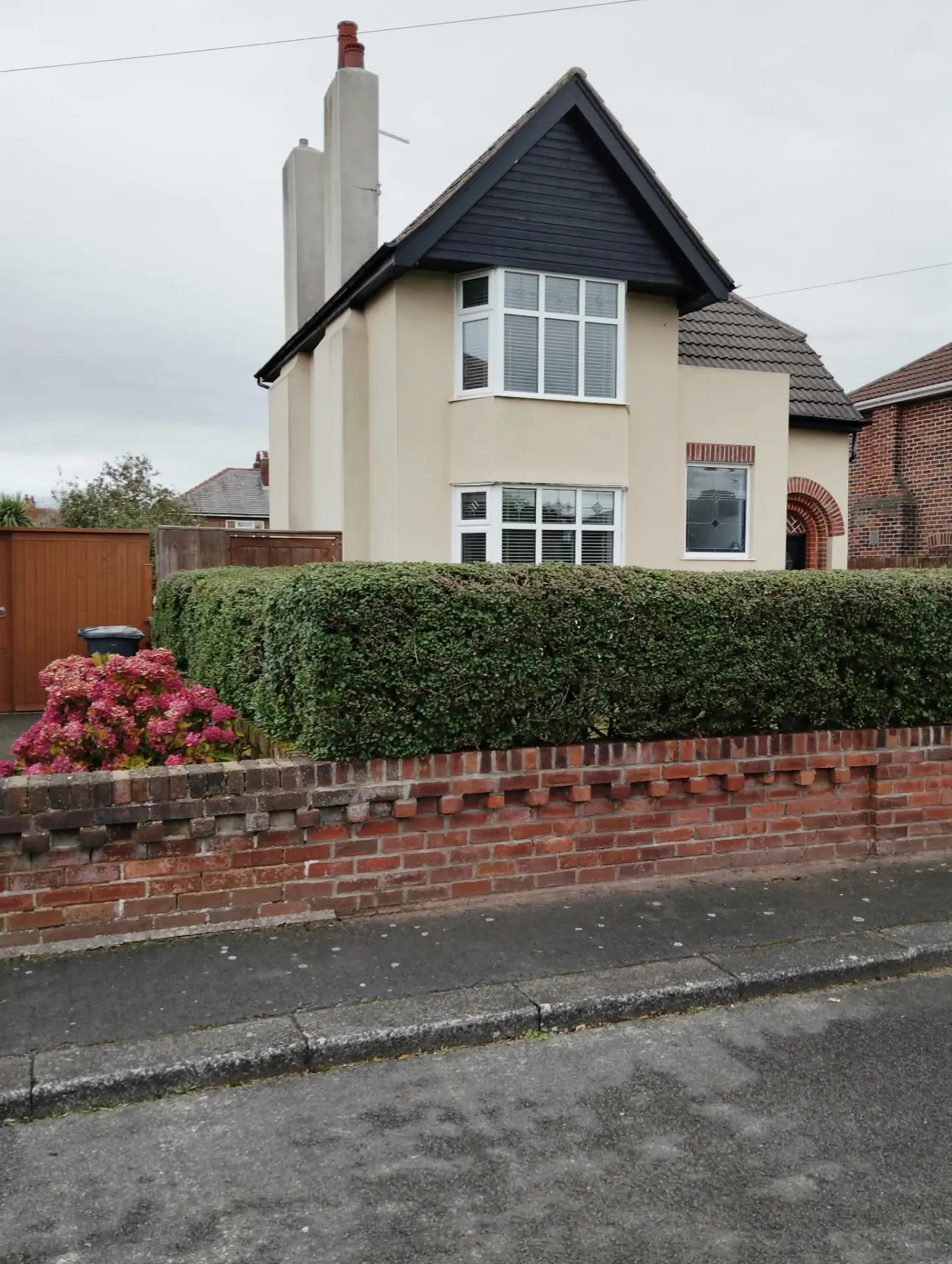 Detached rendered house viewed from the road after a full render clean