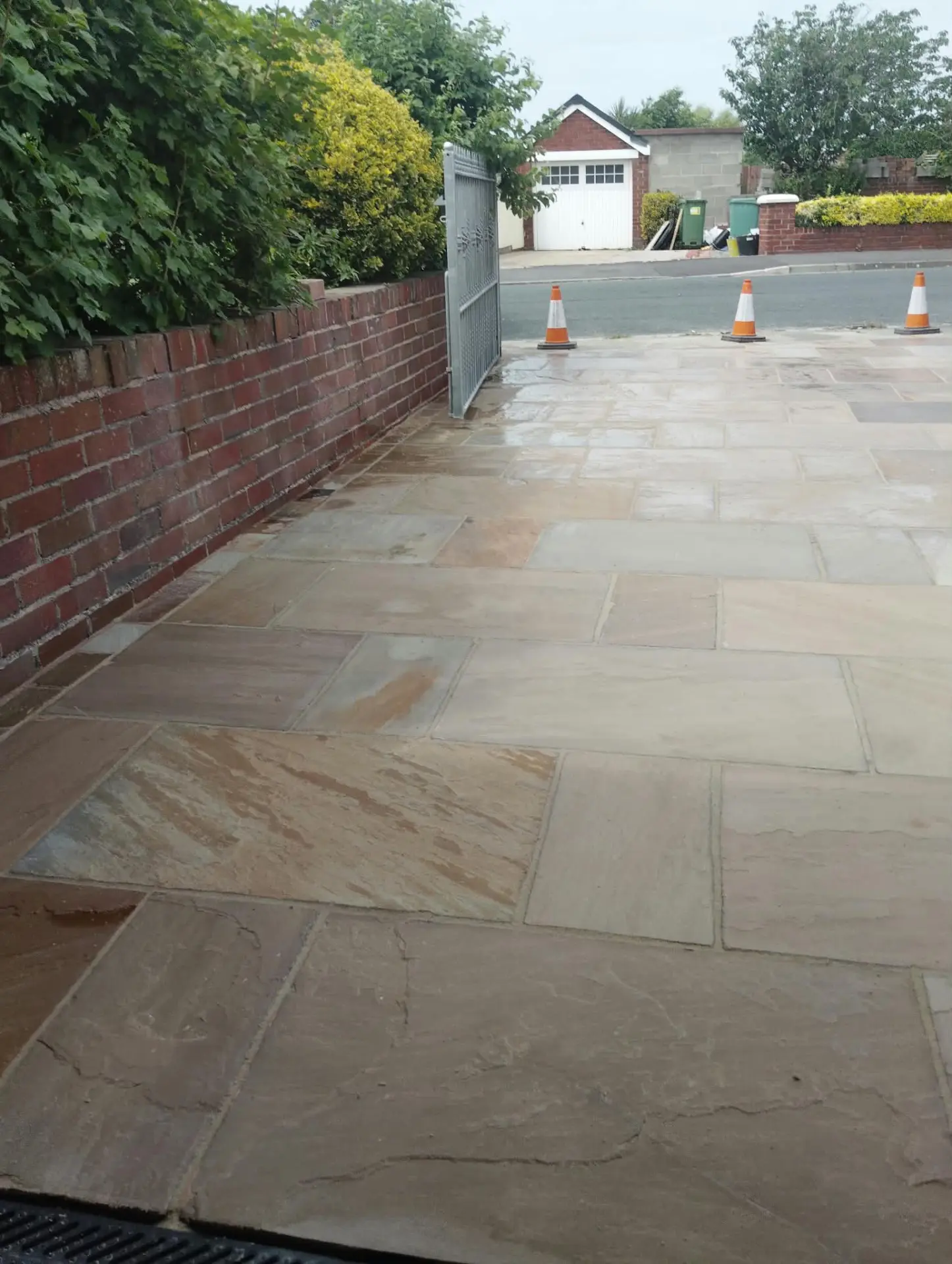 Cleaned sandstone driveway coned off after washing and re-sanding